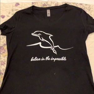 “Believe in the impossible” dolphin design tee